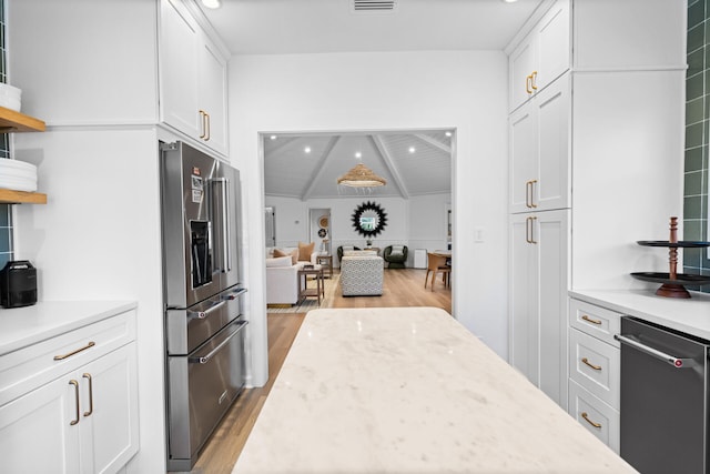 kitchen with light wood-style floors, white cabinets, open shelves, and high quality fridge