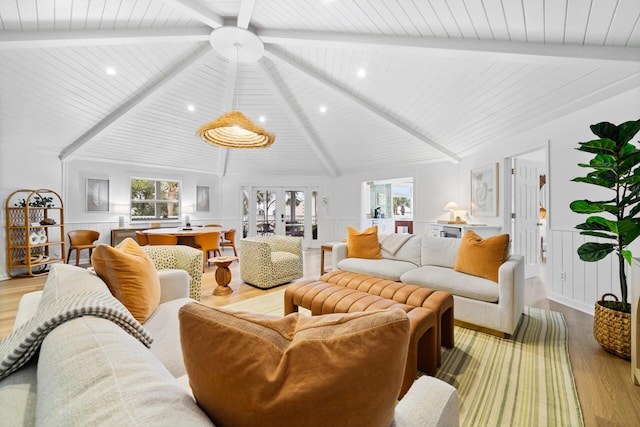 living area with lofted ceiling with beams, a decorative wall, light wood-style flooring, recessed lighting, and wood ceiling