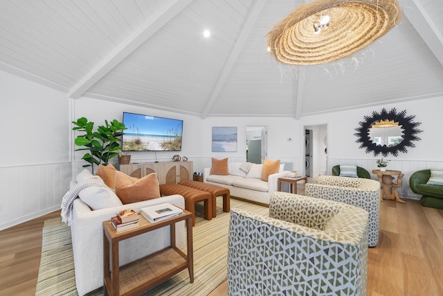 living area featuring high vaulted ceiling, beamed ceiling, wainscoting, and light wood finished floors