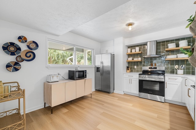 kitchen featuring open shelves, a textured ceiling, appliances with stainless steel finishes, and wall chimney range hood