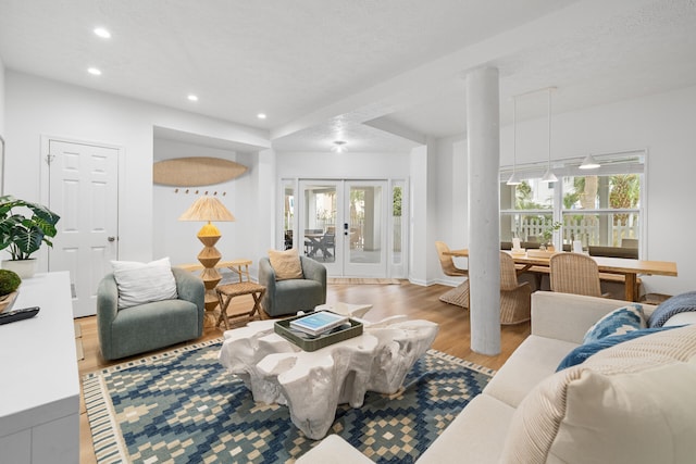 living area featuring recessed lighting, french doors, and light wood-type flooring