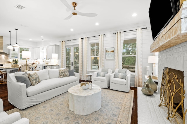117 W Okeechobee, Santa Rosa Beach, FL 32459 - living room featuring a brick fireplace, light wood-style flooring, a ceiling fan, recessed lighting, and visible vents