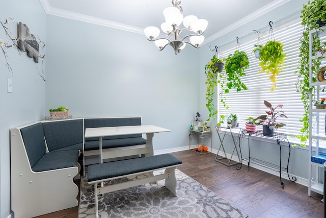 living area with an inviting chandelier, baseboards, crown molding, and wood finished floors
