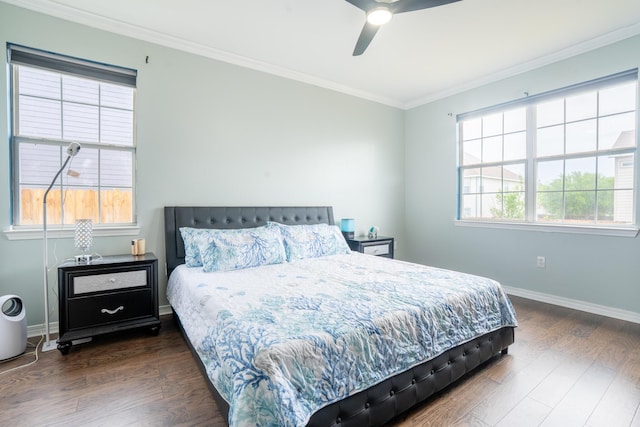 bedroom with baseboards, ornamental molding, a ceiling fan, and dark wood-style flooring