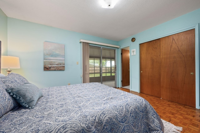 bedroom featuring multiple closets and a textured ceiling