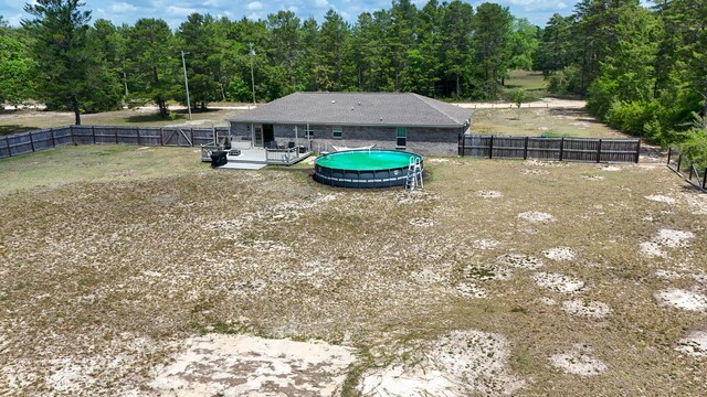 199 W Italian Ave, Defuniak Springs, FL 32433 - fenced backyard featuring a wooded view and a wooden deck