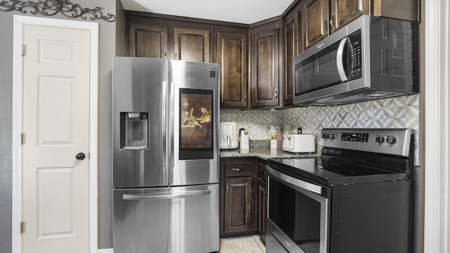 199 W Italian Ave, Defuniak Springs, FL 32433 - kitchen featuring stainless steel appliances, stone countertops, dark brown cabinets, and decorative backsplash