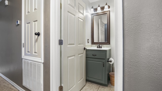 199 W Italian Ave, Defuniak Springs, FL 32433 - bathroom with tile patterned floors, vanity, and a textured wall