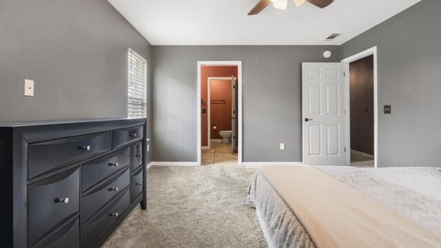 199 W Italian Ave, Defuniak Springs, FL 32433 - bedroom with light carpet, baseboards, ensuite bath, and ceiling fan