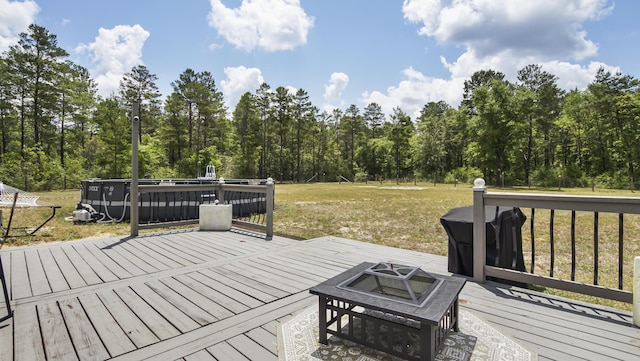 199 W Italian Ave, Defuniak Springs, FL 32433 - wooden deck featuring a fire pit, a yard, and a forest view