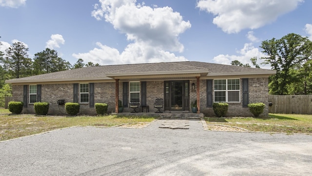 199 W Italian Ave, Defuniak Springs, FL 32433 - ranch-style home with covered porch, brick siding, and a shingled roof