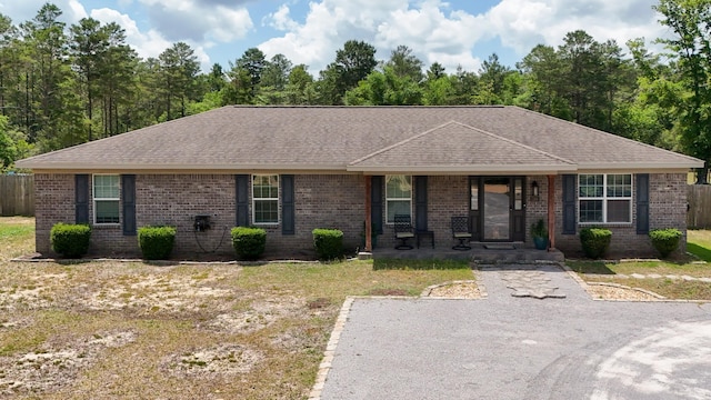 199 W Italian Ave, Defuniak Springs, FL 32433 - ranch-style house with covered porch, brick siding, and roof with shingles