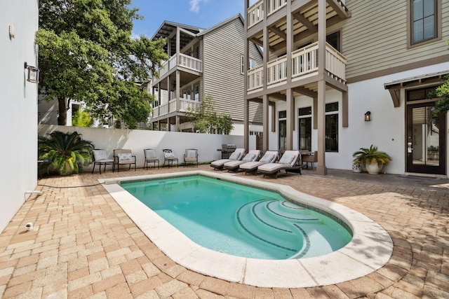 view of swimming pool with a patio, a fenced in pool, and fence