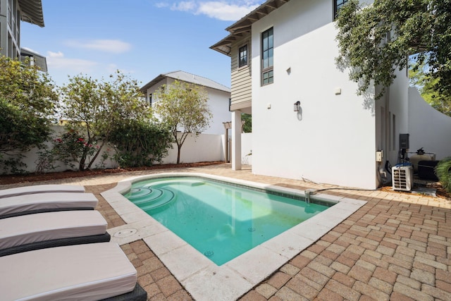 view of swimming pool with a fenced backyard, a fenced in pool, and a patio
