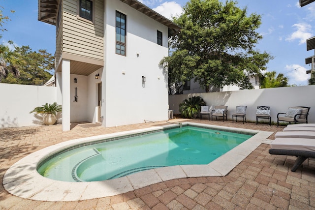view of pool featuring a patio, a fenced in pool, and a fenced backyard