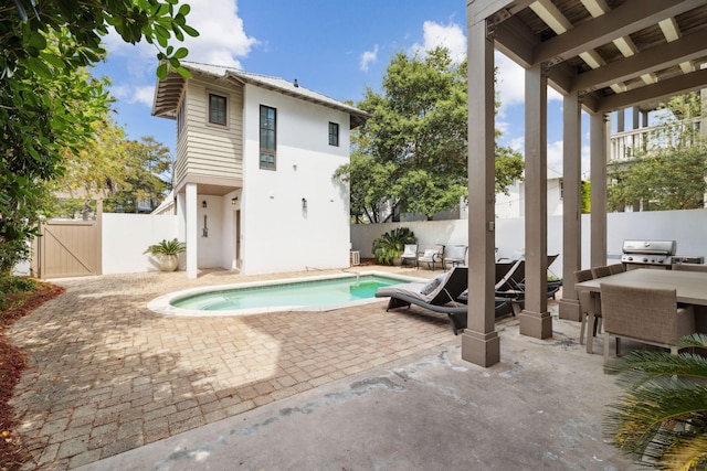 view of pool featuring area for grilling, a gate, a patio area, a fenced backyard, and outdoor dining space