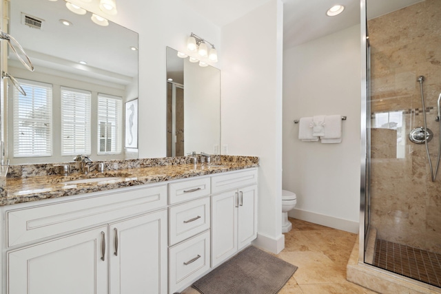 full bath featuring visible vents, double vanity, toilet, a shower stall, and a sink