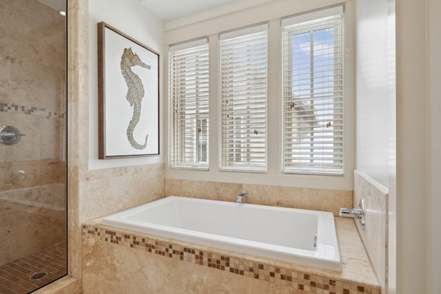 full bath featuring a stall shower and a garden tub