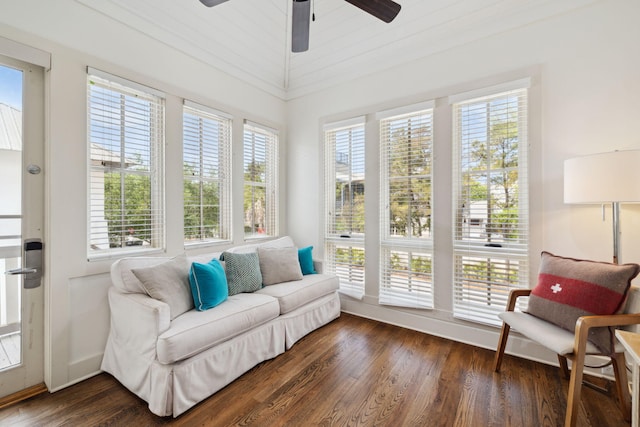 sunroom / solarium featuring baseboards, plenty of natural light, and wood finished floors