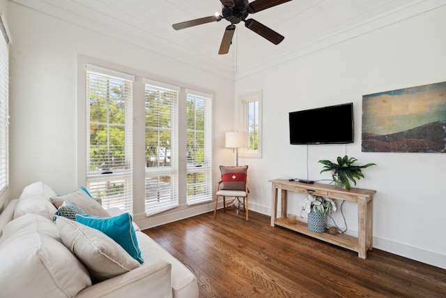 living area featuring baseboards, ceiling fan, and wood finished floors
