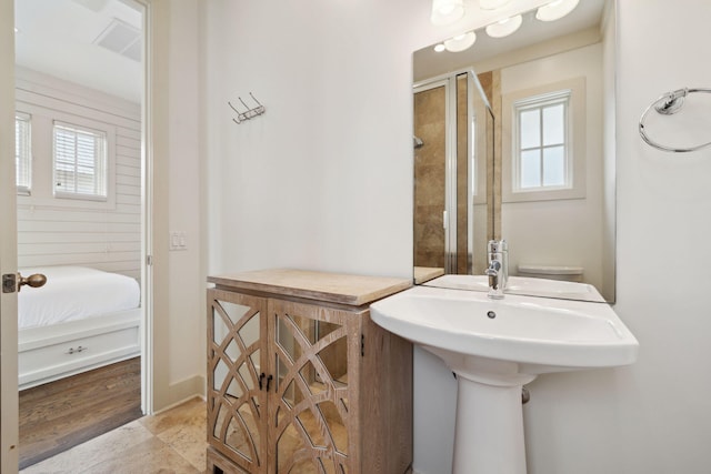 ensuite bathroom with a shower with door and ensuite bathroom