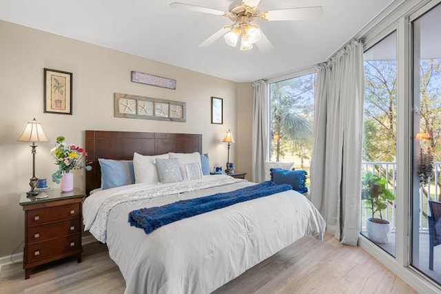 bedroom with light wood-type flooring, baseboards, ceiling fan, and access to outside