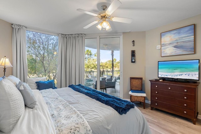 bedroom featuring access to outside, multiple windows, light wood-type flooring, and ceiling fan