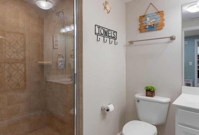 full bath with toilet, a shower stall, and vanity