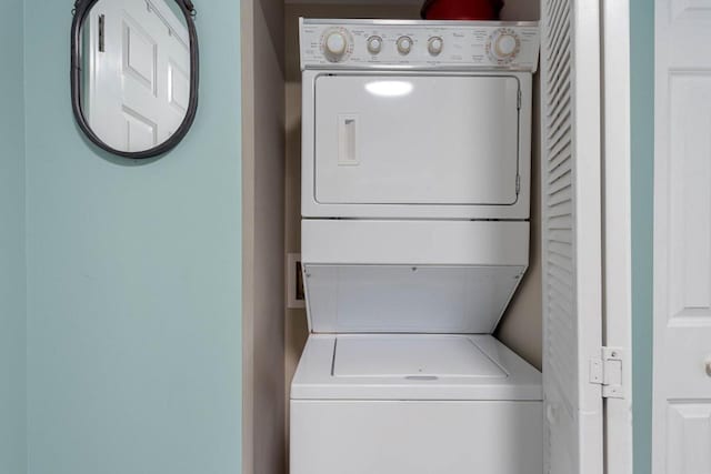 laundry area with laundry area and stacked washer / drying machine