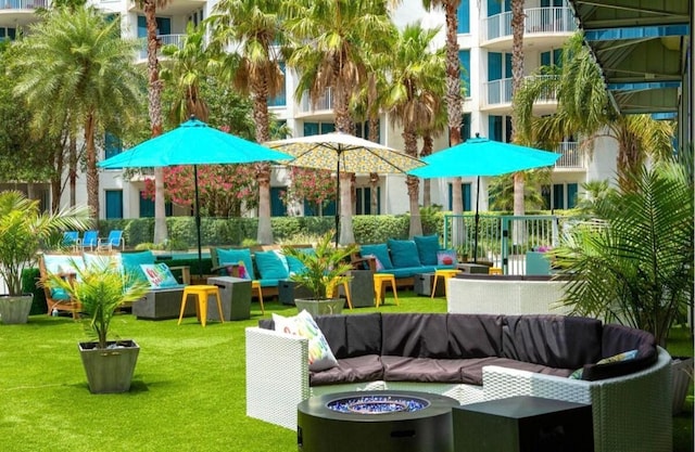 exterior space with an outdoor living space with a fire pit