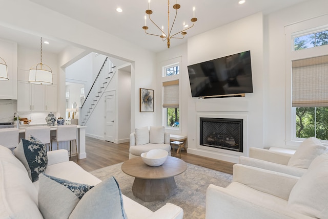 380 N Wall St, Inlet Beach, FL 32461 - living area featuring light wood-style flooring, recessed lighting, a chandelier, stairs, and a fireplace