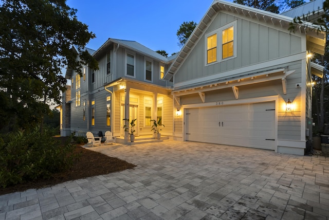 380 N Wall St, Inlet Beach, FL 32461 - view of front of home featuring board and batten siding, an attached garage, and decorative driveway