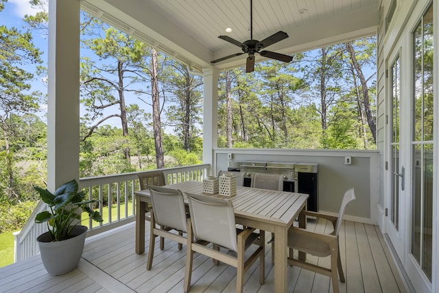 380 N Wall St, Inlet Beach, FL 32461 - deck with outdoor dining area, ceiling fan, and view of wooded area