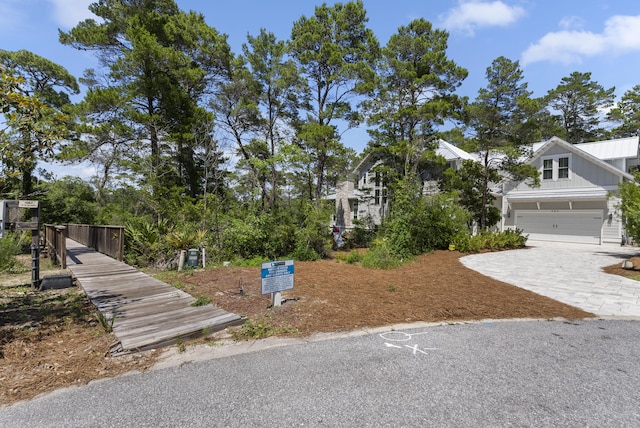 380 N Wall St, Inlet Beach, FL 32461 - view of front of house with decorative driveway, an attached garage, and board and batten siding