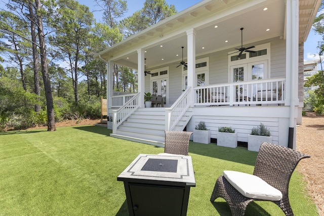 380 N Wall St, Inlet Beach, FL 32461 - rear view of house with a ceiling fan, a lawn, a fire pit, and stairway