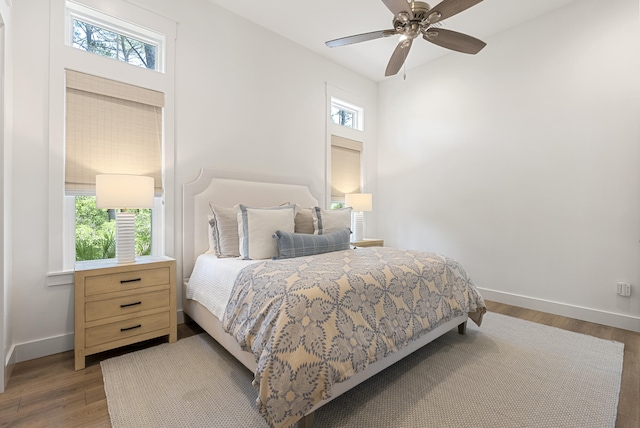 380 N Wall St, Inlet Beach, FL 32461 - bedroom featuring multiple windows, wood finished floors, and baseboards