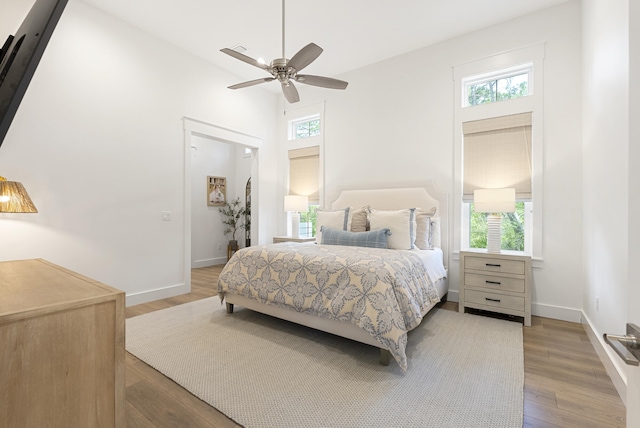 380 N Wall St, Inlet Beach, FL 32461 - bedroom featuring multiple windows, light wood-style flooring, and baseboards
