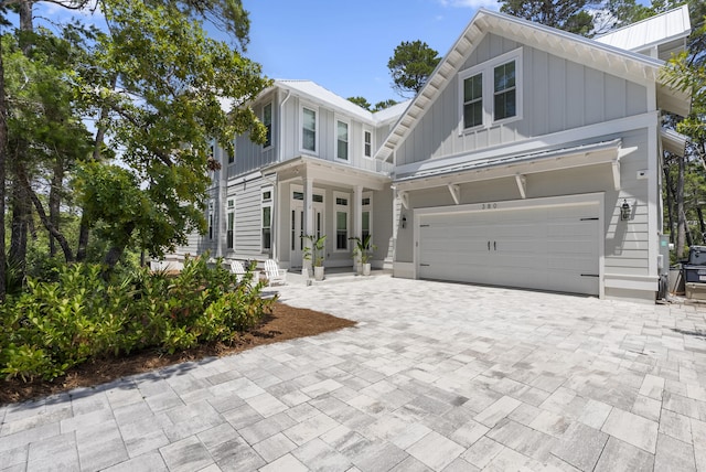 380 N Wall St, Inlet Beach, FL 32461 - view of front of house with board and batten siding, a garage, and decorative driveway