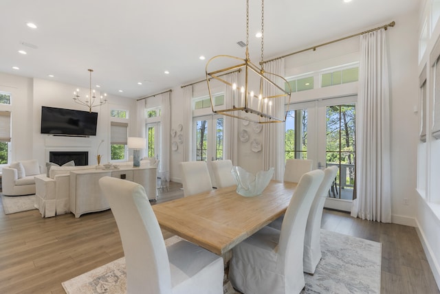 380 N Wall St, Inlet Beach, FL 32461 - dining area featuring a chandelier, recessed lighting, french doors, wood finished floors, and a fireplace