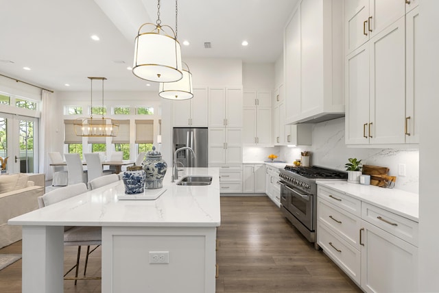 380 N Wall St, Inlet Beach, FL 32461 - kitchen with stainless steel appliances, a sink, white cabinets, recessed lighting, and a kitchen bar