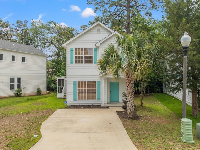 114 Rearden Way, Santa Rosa Beach, FL 32459 - view of front of house featuring a front yard, a sunroom, and concrete driveway