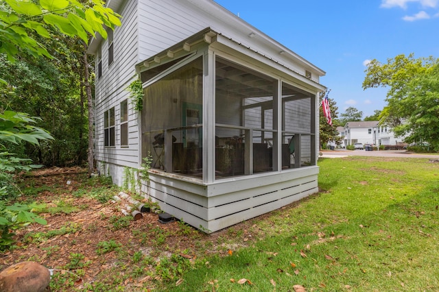 114 Rearden Way, Santa Rosa Beach, FL 32459 - view of side of home featuring a sunroom and a lawn