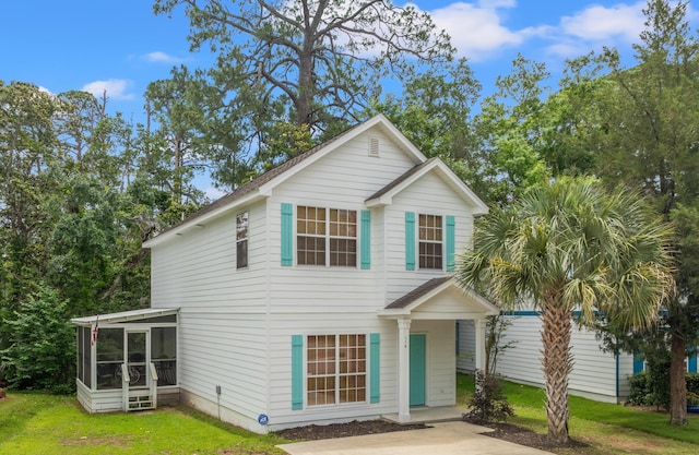 114 Rearden Way, Santa Rosa Beach, FL 32459 - view of front facade featuring a sunroom and a front yard