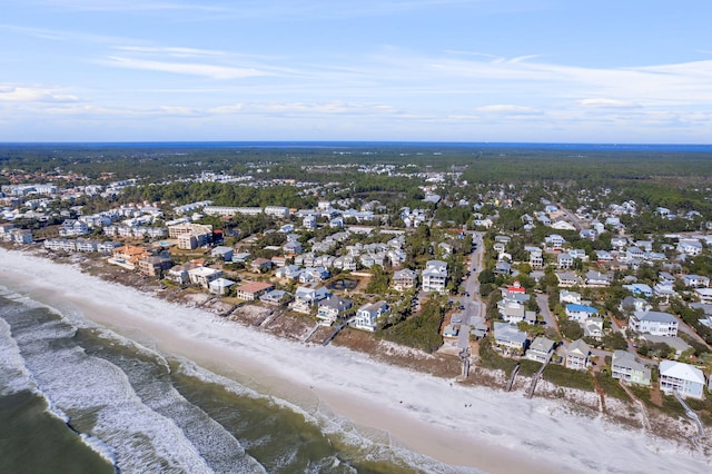 view of property location featuring nearby suburban area and waterfront with a beach