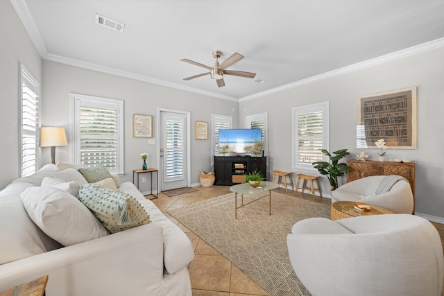 living area with crown molding, tile patterned floors, ceiling fan, and baseboards