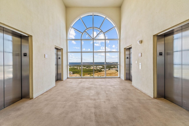 interior space with a high ceiling and elevator