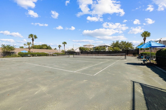 view of tennis court featuring fence