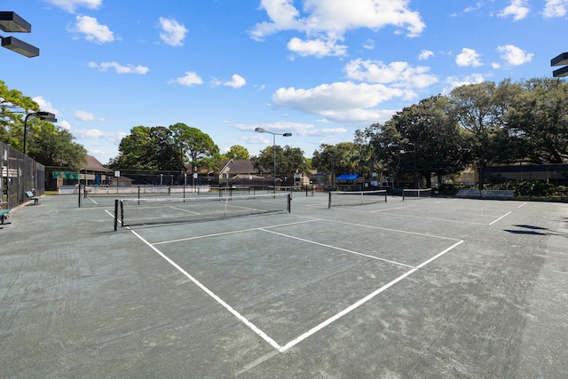 view of sport court featuring fence
