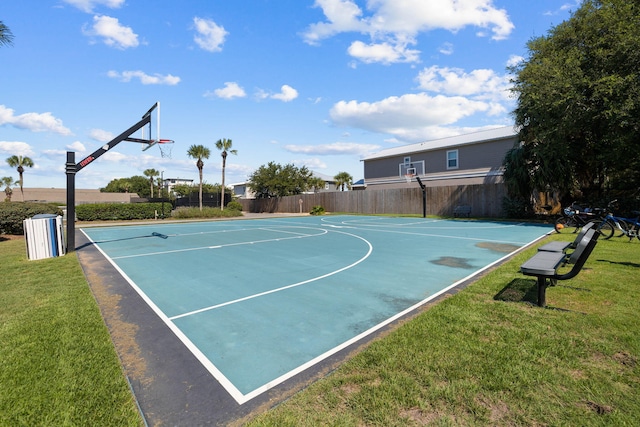 view of sport court featuring a yard, community basketball court, and fence