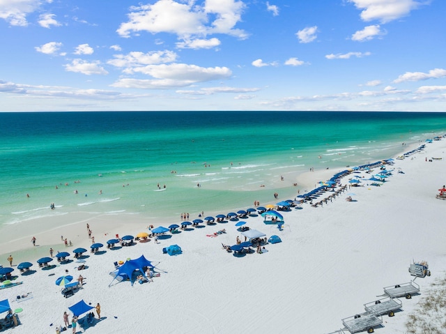 drone / aerial view featuring a water view and a beach view